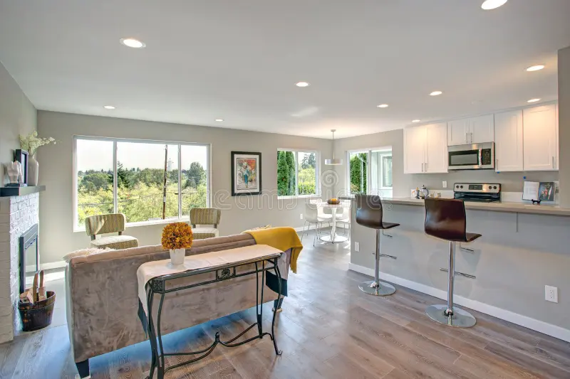 freshly remodeled home interior open floor plan tons natural light features living space fireplace white kitchen 105037936